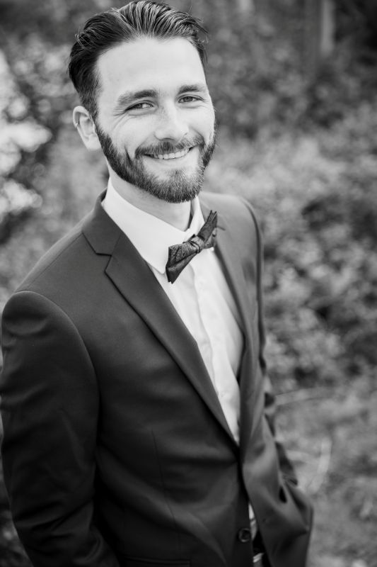 man in black and white image at a wedding