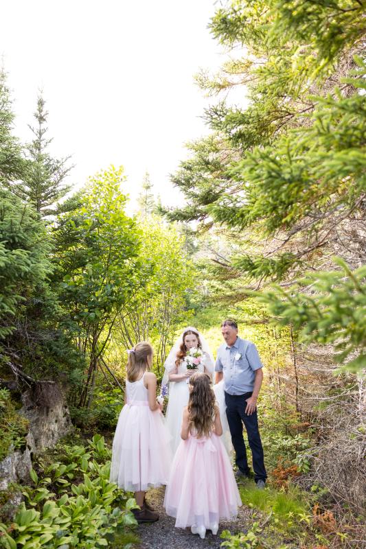 bride and kids standing together with father