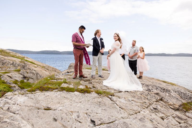 wedding photography session with the groom and bride on a large rock in newfoundland